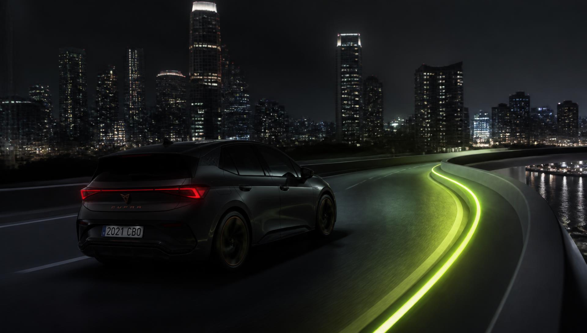 An electric hatchback tracing a lime-lit curve of highway past a night skyline